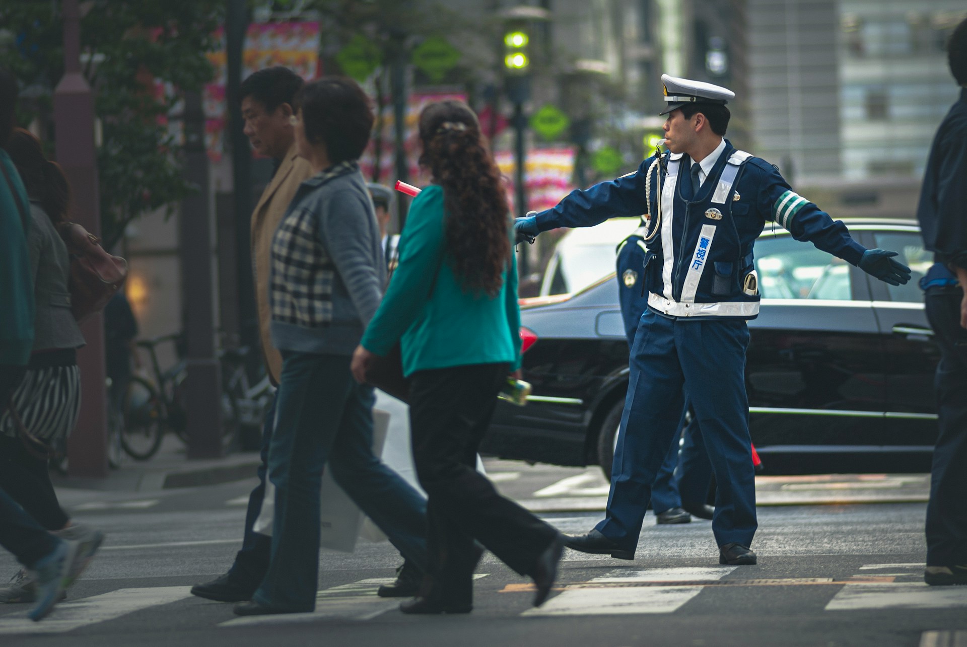 Man in blue jacket and blue denim jeans standing beside woman in red jacket