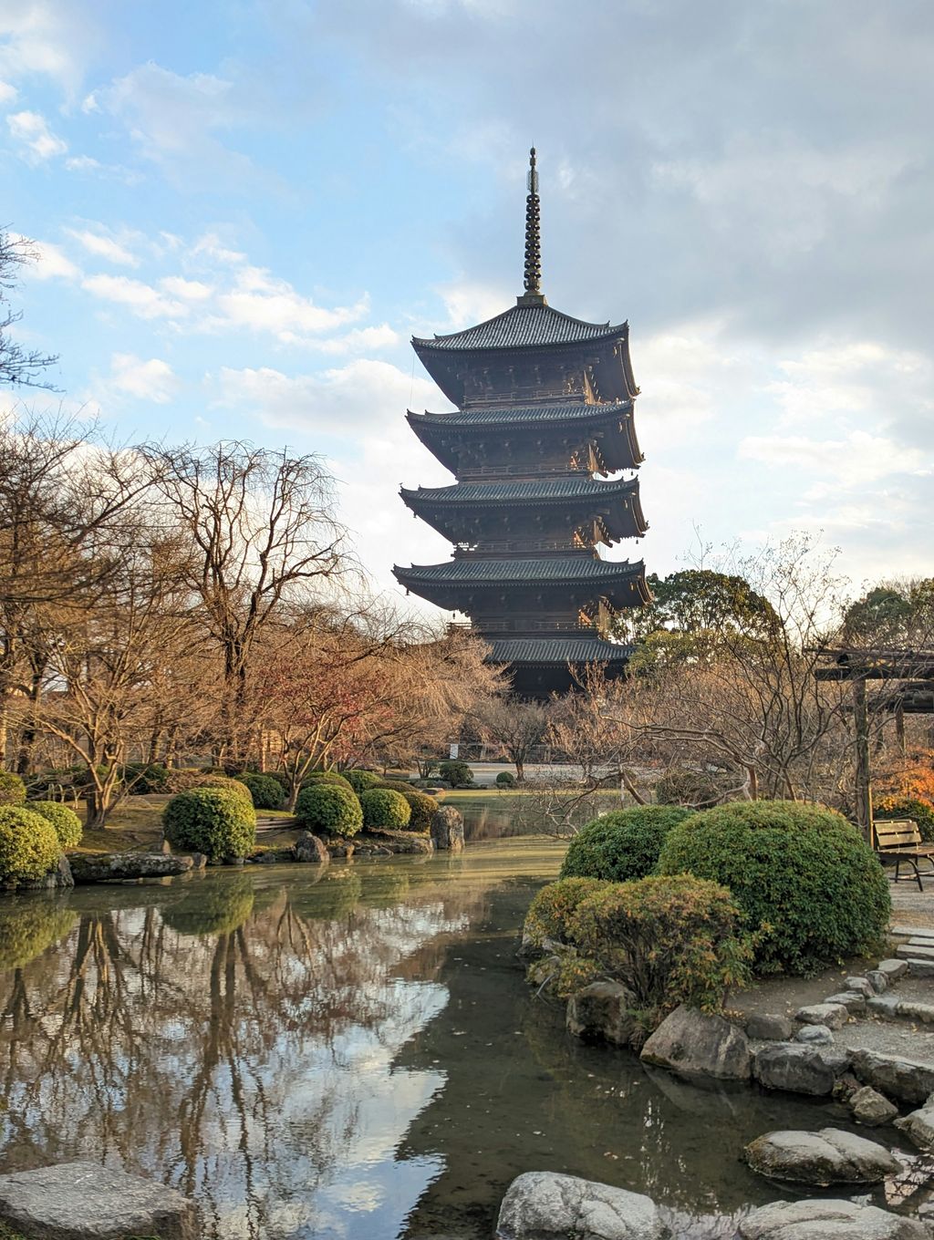 Five-story pagoda of Tō-ji temple, Kyoto, reflected in a pond at dusk
