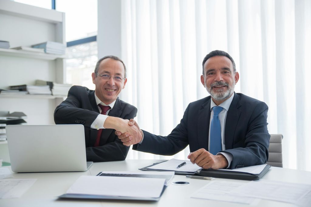 Business partners shaking hands over a service agreement