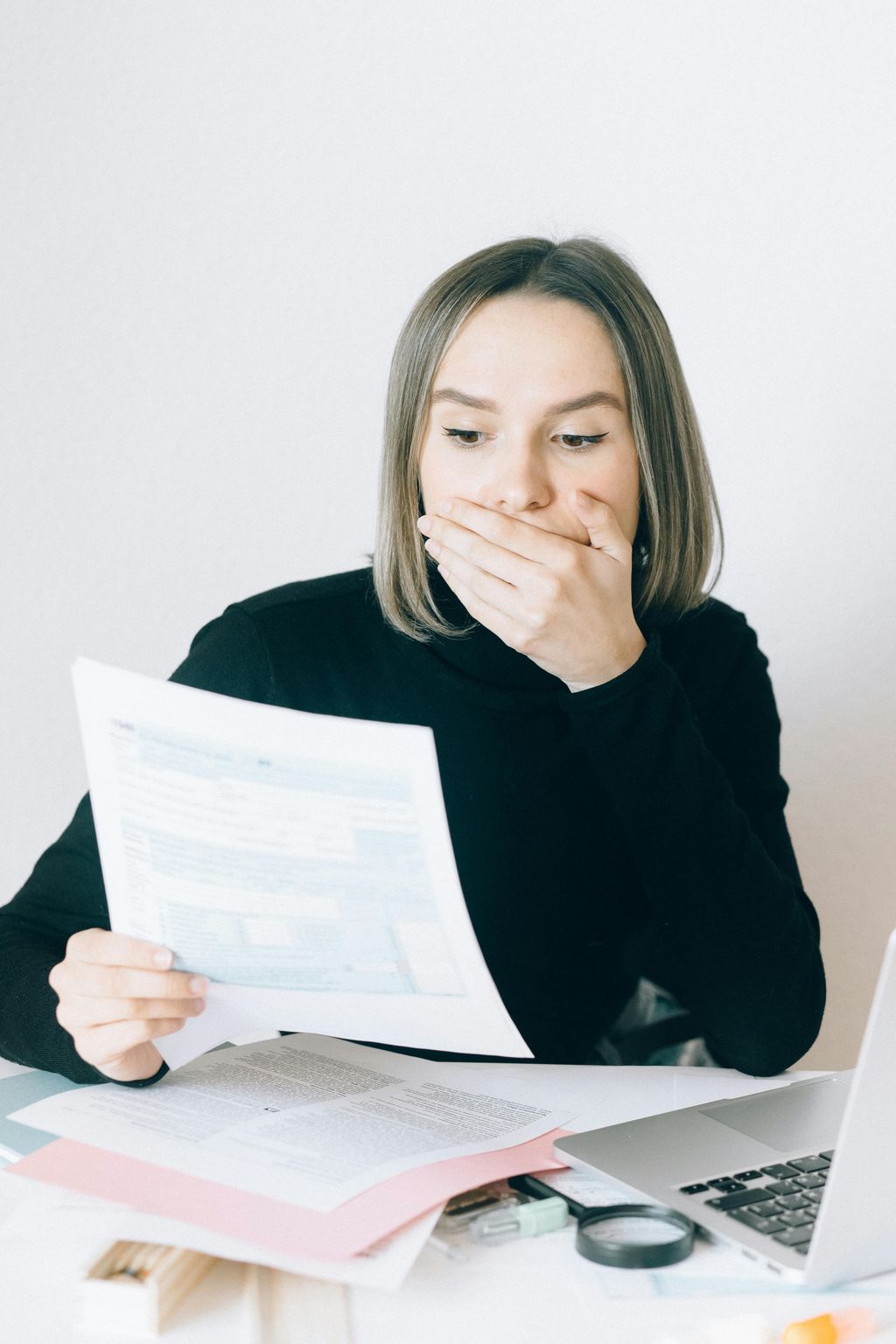 Overwhelmed employee reviewing unfamiliar IT documentation